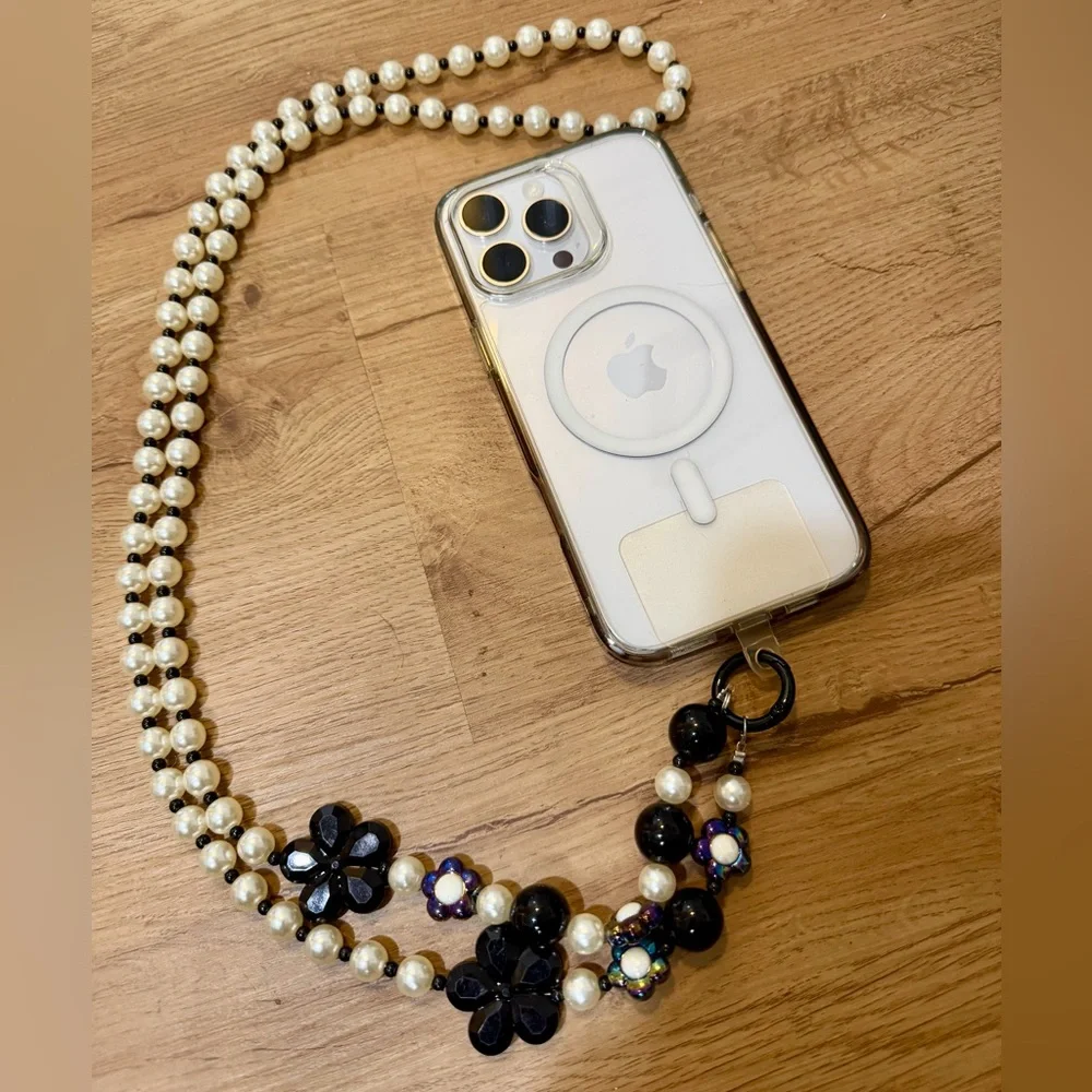 Elegant White and Black Phone Chain with Pearl Strap